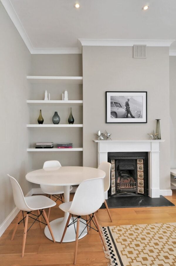 paint your floating wooden shelves next to fireplace for a simple white and grey dining room with sleek displays