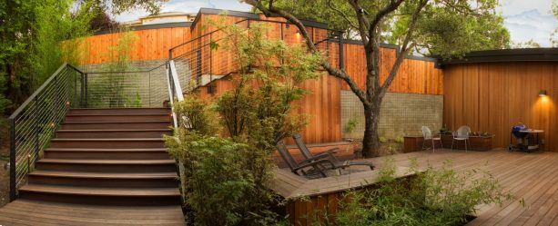 the spacious stair gets extra protection from the black metal and cable railing