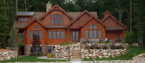 combination of cedar shakes and metal roof in a log style cabin