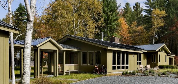 olive painted cedar exterior paint color in a spacious ranch house