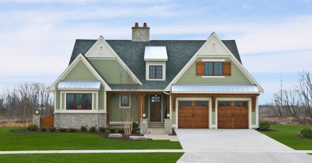 traditional green siding and wood elements in a rustic cottage house