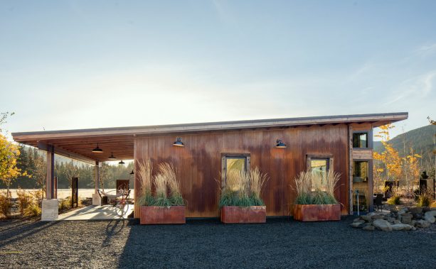 wood-trimmed single windows in a metal building with an industrial exterior