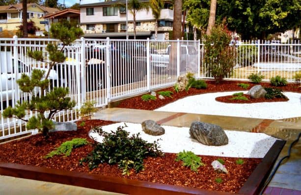 stone landscaping in a grassless front yard with gravel and boulders