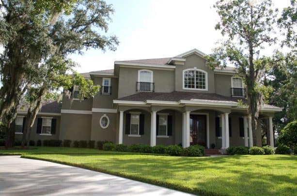 the use of taupe stucco and white trim for a classic neutral look in a traditional exterior