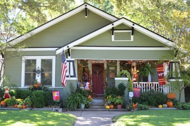 spanish moss green siding house exterior paired with black and white trim