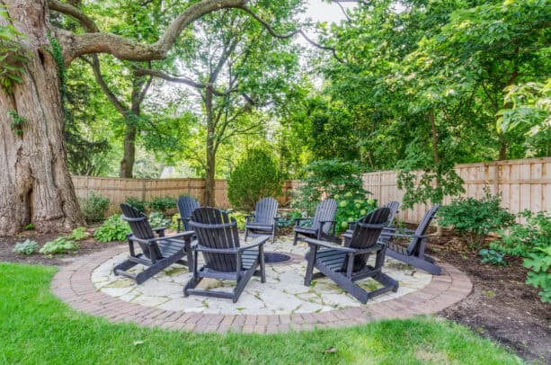 brick border in a round stone slab patio