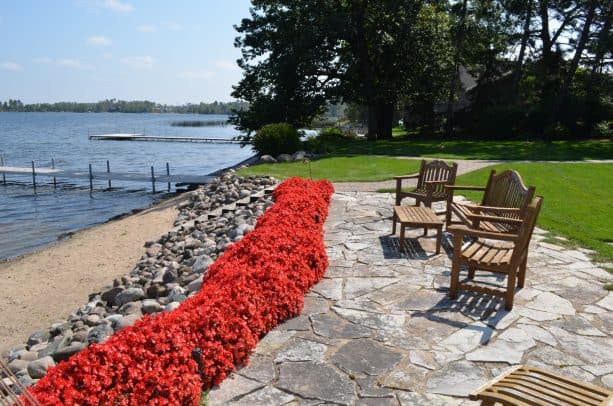 when rip rap retaining walls lead the way to a backyard stone patio