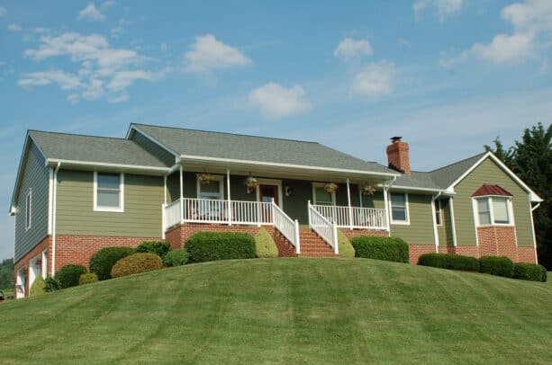 a sage green james hardie lap siding combined with white trims for an eye-pleasing exterior