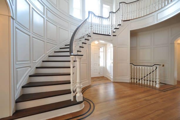 staircase with raised panel wainscoting