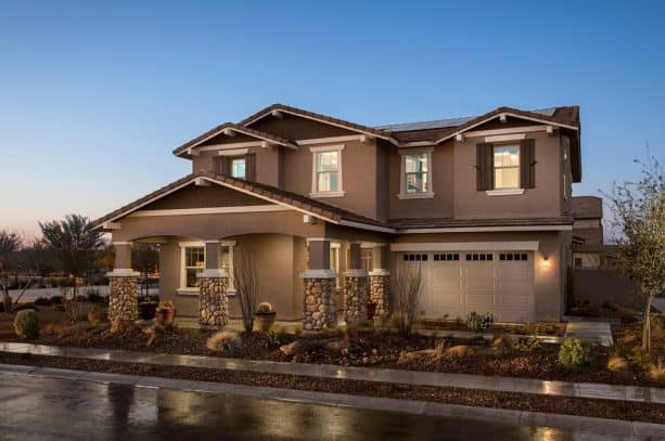 mediterranean exterior with brown stucco material and white trim