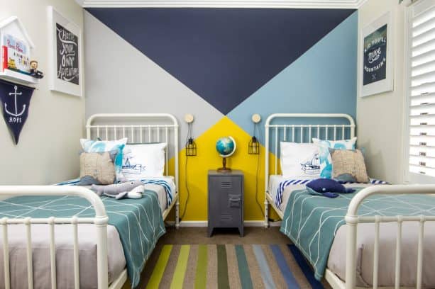 a shared bedroom with 4-tone, including navy, accent wall