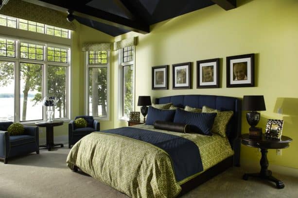 a traditional bedroom with green and navy theme