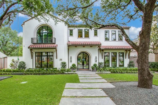 a mediterranean exterior with Tuscan white stucco wall and off-white trim