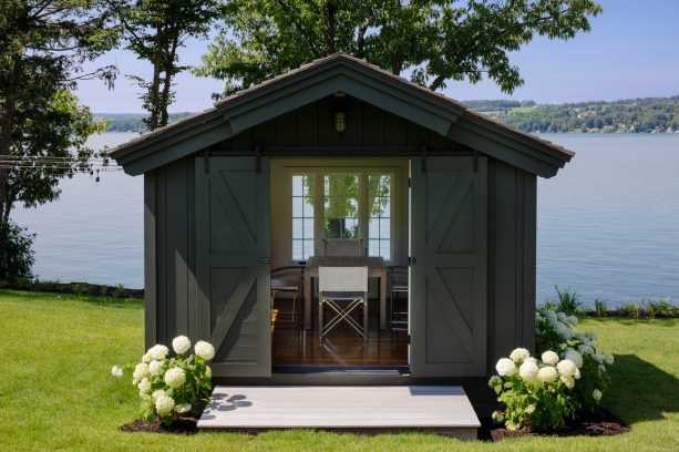 greyish brown writing and workshop studio shed with double sliding door garage door