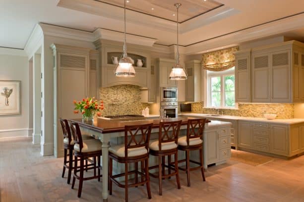 muted sage green cabinets in a l-shaped traditional kitchen