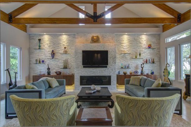 adorable built-in glass shelves around a quartz stone fireplace