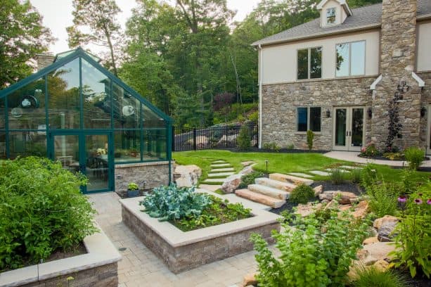 mountainside living with a few stone steps to the raised planters on a slope landscape