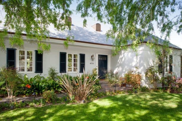 one-story white house with blue lagoon shutters from timberlane