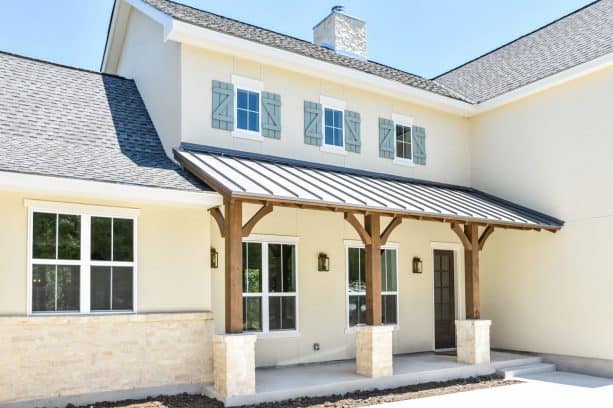 softer tan-white stucco walls by sherwin william featuring blue window shutters on top