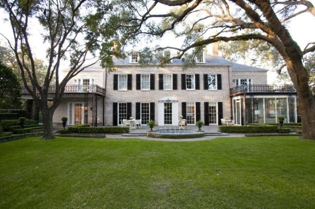 traditional brick house exterior with dark shutters