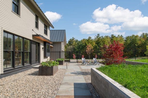 stone front yard patio in a trendy farmhouse style with a container garden