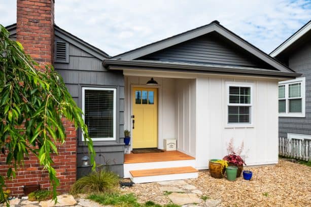 black and white exterior paired with a yellow front door