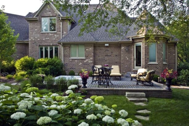 open raised patio completed with in-ground hot tub and seating