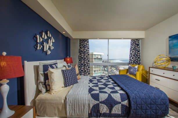 a denim wall and a standing-out canary chair for a cool coastal bedroom