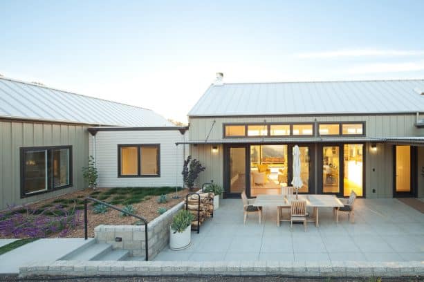 a standing seam metal roof with a galvalume finish shading a country patio