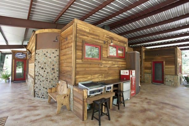 a super wide steel roof cover design was protecting a mountain style patio