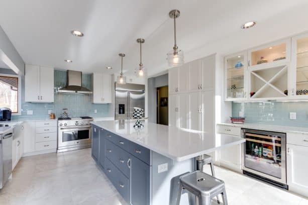 a clean and crisp look is born when white shaker cabinets meet a sherwin williams web gray cabinet and a blue glass tile backsplash