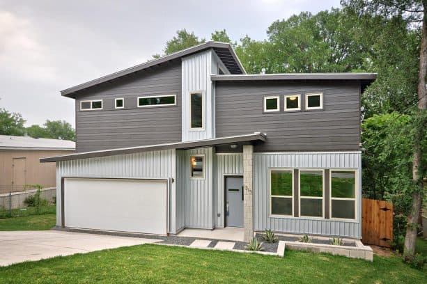 a unique baby is guaranteed to be born when a grey front door is accompanied by silver corrugated metal walls and a dark hardy plank siding