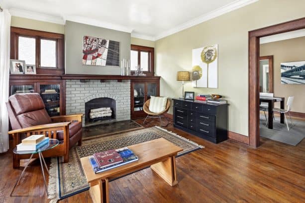 transitional living room with gray painted brick fireplace