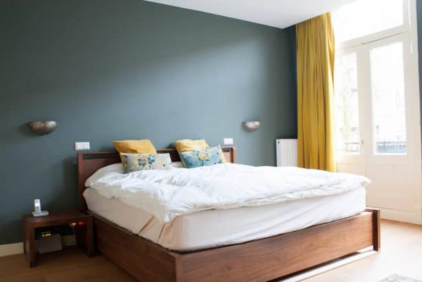 a bedroom with teal and mustard theme