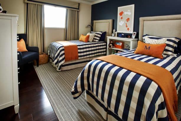 a navy blue bedroom with orange accents