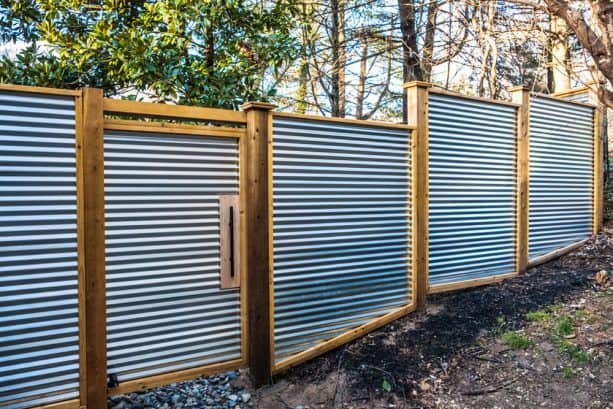 corrugated metal fence built on sloped land