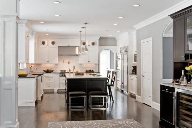 clean traditional kitchen with grey walls and oak-stained floor