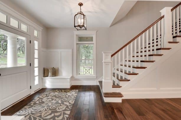 transitional entry with grey paint and walnut floor