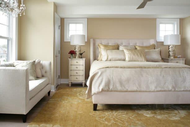 gold area rug with white flowers patterns in a neutral transitional bedroom