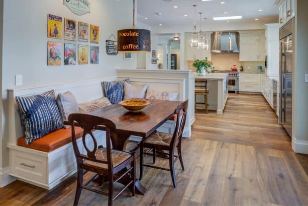 a small half wall dividing the open space between a kitchen and a farmhouse dining room