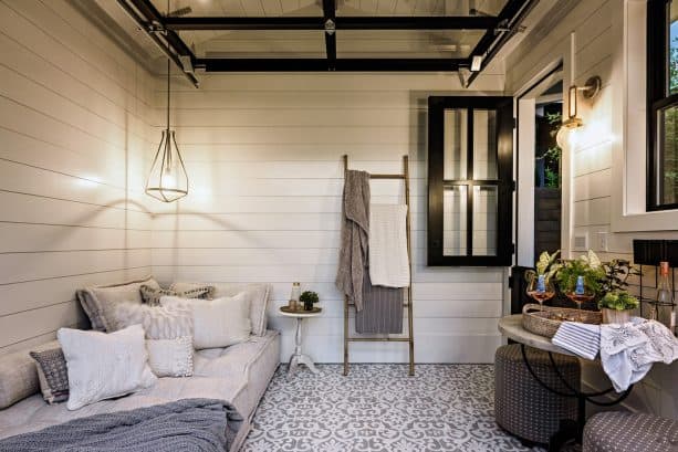 a closer look to the guest shed interior showing the sectional garage door on the ceiling