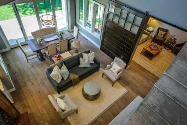 a huge barn door painted in black with windows to divide two rooms