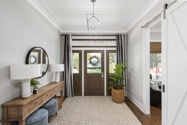 combination of the large brown front door and gray walls