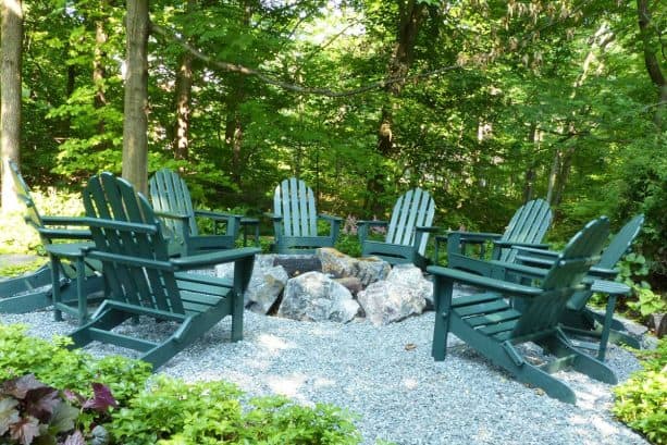 bluestone pea gravel patio with a sunken fire pit surrounded by large granite boulders