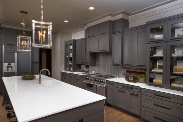 dark gray cabinets and gray tiled backsplash in a transitional kitchen