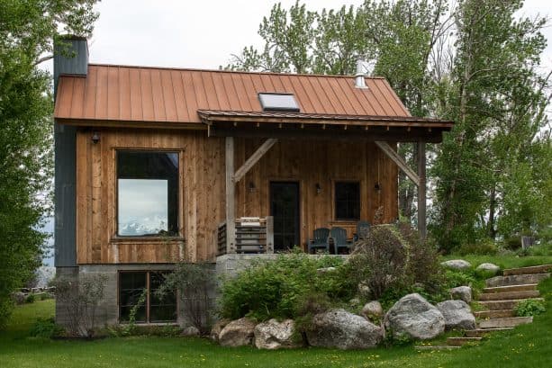 hip metal roof in bronze finish for a small log cabin