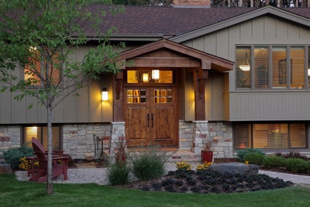 wood portico with custom built cedar beams and brackets framing a double front door