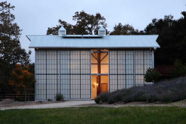 a kallwall panel sliding barn door welcoming guests to a mid-sized country home