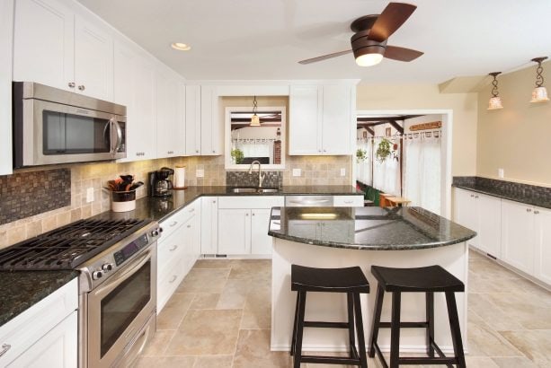 contemporary kitchen with white cabinets and beige wall paint color