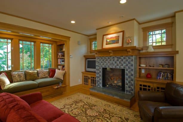 a tile-surround fireplace with douglas fir built-in book shelves